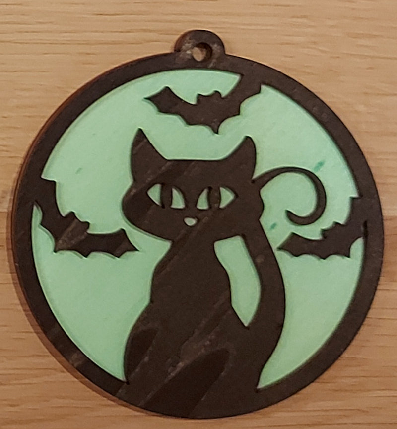 Houten en gekleurde Halloween decoratie. Halloween hanger met gravure kat en vleermuizen